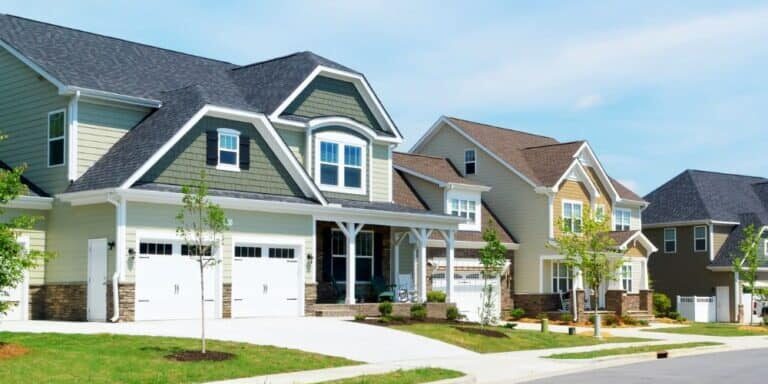 Row of suburban homes with different exterior siding colors, including sage green and tan, showcasing home exterior color options